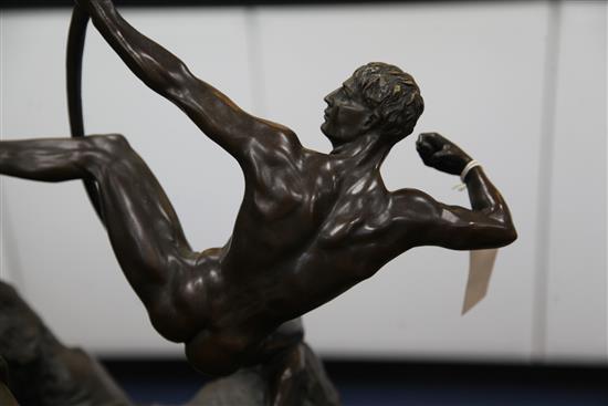 A bronze figure of a nude archer standing upon a rocky outcrop, 22in.